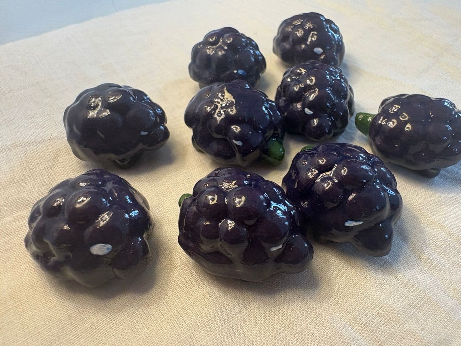 Glossy miniature fruit pieces on fabric
